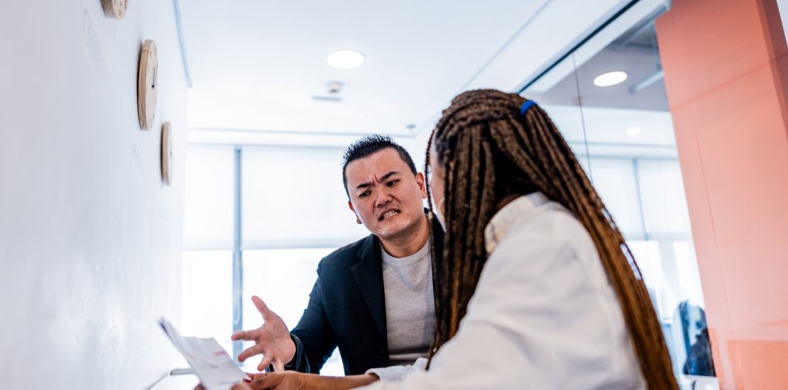 Mid adult leader man complaining to employee at office