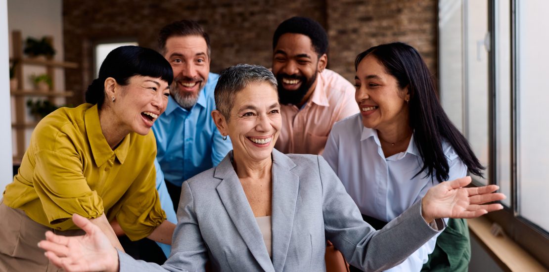 Diverse business colleagues celebrating success in the modern office, fostering togetherness and achieving goals with a joyful, inclusive, and collaborative environment